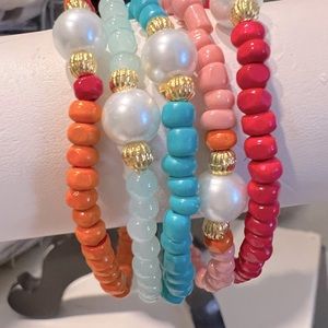 Stack of 5 seed bead stretchy bracelets with pearl and gold accents